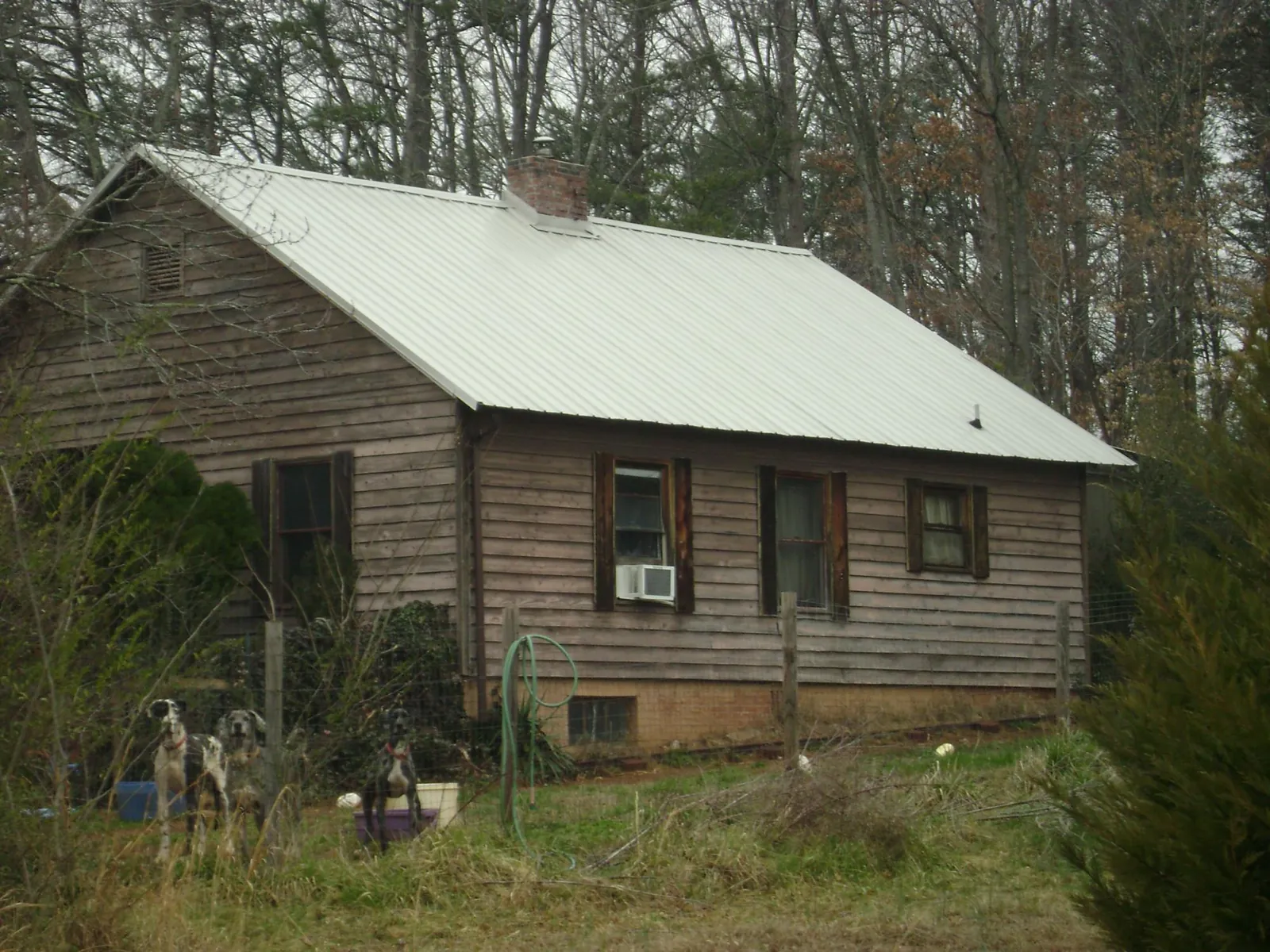 White metal roof on an old wood sided farmhouse, from a Metal Roof Installation job in Huson